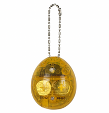Load image into Gallery viewer, Jurassic Park 30th Anniversary Tamagotchi Dinosaur Amber Version